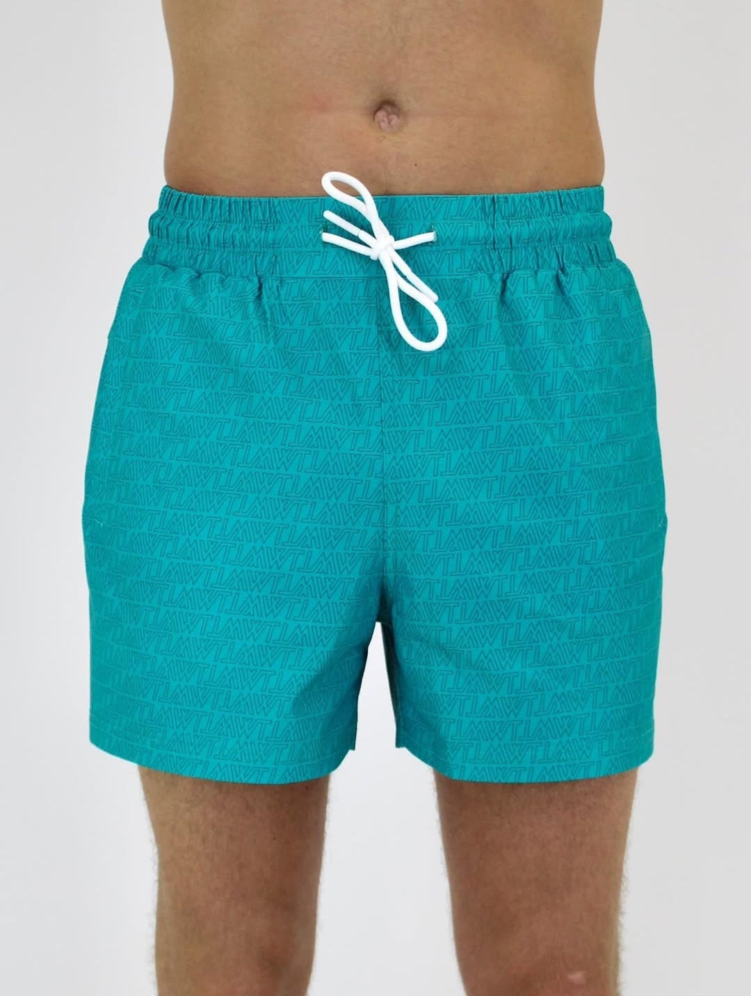 Teal swim shorts worn by a person on a white background